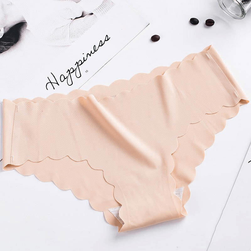 Solid Color Low Waist Ruffle Stretch Briefs in beige with scalloped edges laying on a white background near a magazine and coffee beans.